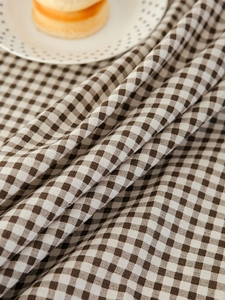 Detailed macro view of the brown and white checkered linen tablecloth texture
