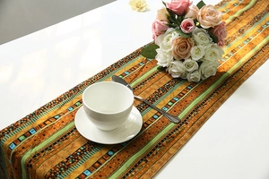 Detailed view of bohemian table runner with geometric ethnic patterns on white table