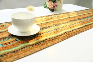 Close-up of geometric ethnic table runner with cotton linen texture on a white dining table