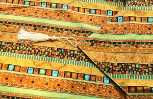 Close-up of ethnic cotton linen table runner with geometric patterns and fringe tassels