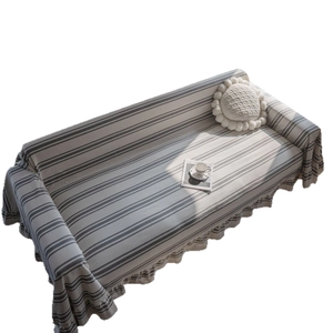 Modern striped sofa cover in cream white with ruffled edges and elegant drape