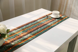 Bohemian geometric pattern table runner on white table with soft window lighting