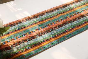 Detailed view of bohemian cotton linen table runner with colorful ethnic geometric patterns