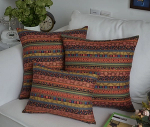 Bohemian ethnic patterned throw pillow covers displayed on a white sofa in a cozy room
