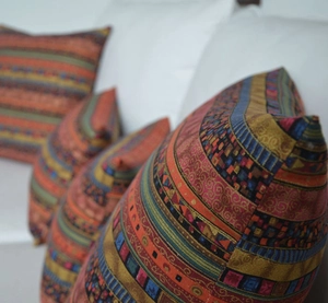 Close-up of ethnic bohemian throw pillowcase with intricate woven geometric patterns