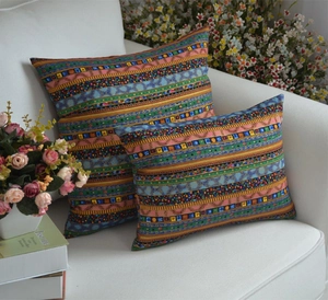 Bohemian style rainbow striped square and rectangular throw pillow covers on a white sofa