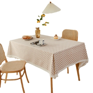Pastoral rectangular strawberry print tablecloth with white lace edges on a dining table
