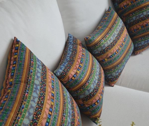 Close-up of bohemian cushion cover with ethnic geometric patterns on white sofa