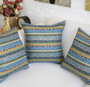 Detailed texture of bohemian ethnic cushion covers on a sofa in a home setting