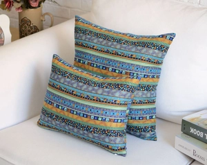 Detail of bohemian striped decorative pillows on a sofa showing fabric texture and patterns