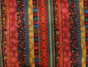 Detailed close-up of ethnic style cotton linen table runner with red bohemian patterns