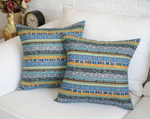 Close-up of square throw pillow covers with vibrant ethnic geometric stripe patterns