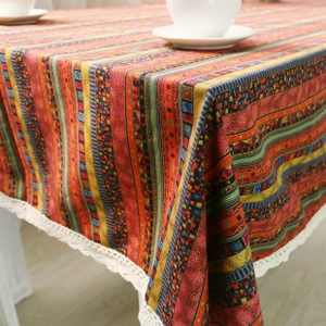 Close-up of Bohemian printed cotton linen tablecloth with delicate white lace border details