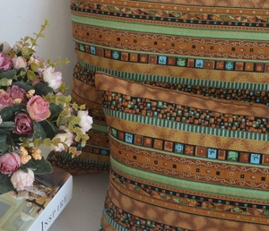 Detail of ethnic geometric pattern fabric on soft bohemian style sofa cushion covers
