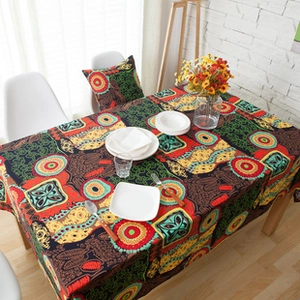 Detail of bohemian cotton linen tablecloth featuring colorful patterns and tassel edges