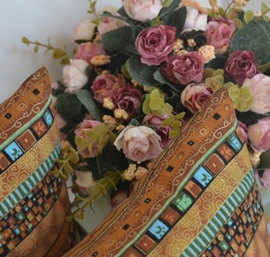 Detail of bohemian geometric throw pillow cover with ethnic sun and moon patterns