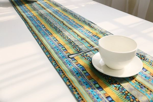 Close-up of bohemian geometric cotton linen table runner with colorful Nordic patterns