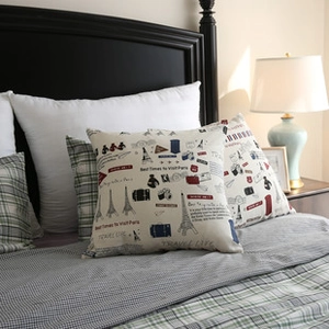 Close-up of bohemian linen pillowcase featuring vintage Eiffel Tower and camera prints