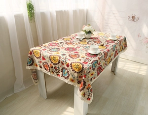 Detail of bohemian mandala linen tablecloth with intricate white lace border edges