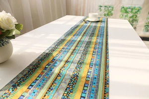 Ethnic geometric pattern table runner on a white dining table with coffee set and roses
