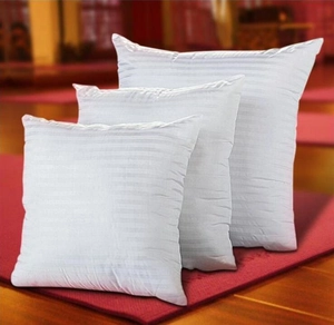 Detail view of three white striped cushion inserts showing soft PP cotton filling