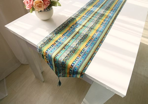 Detailed macro view of colorful striped table runner with elegant tassels and fringe