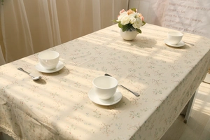 Close-up of rustic floral cotton linen tablecloth with delicate lace edging detail