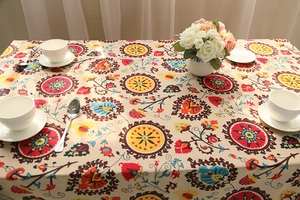 Close-up of Bohemian linen tablecloth featuring colorful mandala patterns and floral details
