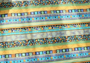 Macro detail of bohemian cotton linen table runner with ethnic geometric patterns