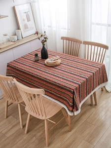 Detail of bohemian rectangle tablecloth featuring colorful stripes and white lace trim