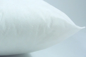 Macro shot of breathable non-woven white pillow insert fabric with mesh texture