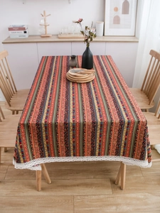 Detail view of Bohemian striped table linen with white crochet lace border decoration