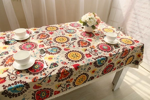 Detail of bohemian cotton linen tablecloth with vintage floral pattern and lace edge