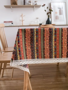 Close-up of bohemian striped cotton linen tablecloth with delicate white lace edges