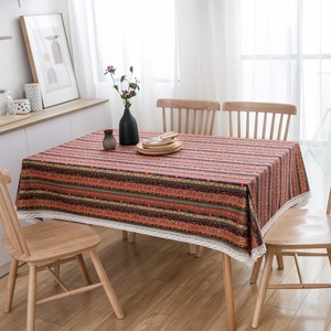 Close-up of bohemian striped cotton linen tablecloth with delicate white lace edges