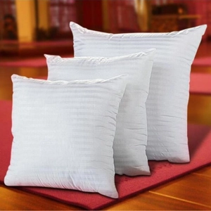 Three white square pillow inserts in varied sizes with striped texture on red background