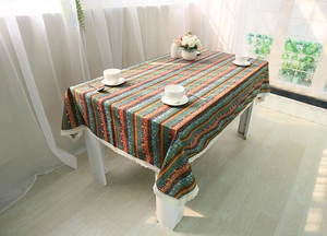 Close-up of Bohemian cotton linen tablecloth featuring ethnic stripes and white lace trim
