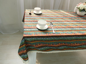 Detail of colorful Bohemian striped linen tablecloth with white crochet lace border