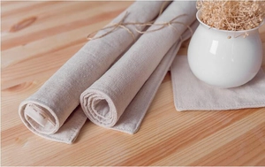Detailed macro view of natural linen placemat set with simple linen label and hemp rope ties