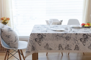 Detail of vintage French tablecloth with butterfly motifs and delicate crochet lace trim
