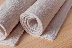 Detailed macro view of woven beige linen table mat with durable stitched edge texture