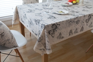 Close-up of vintage butterfly print tablecloth with elegant crochet lace edges