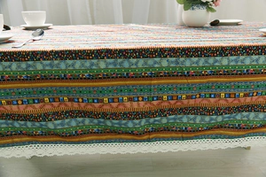 Close-up of bohemian striped linen tablecloth with decorative white lace border edge