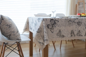 Detail of vintage French style tablecloth with lace edge and butterfly print