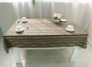 Detail showing bohemian striped linen tablecloth with decorative white lace border