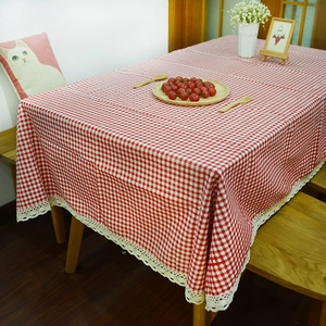 Red and white checkered linen tablecloth with delicate lace trim on a rectangle table