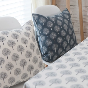 Modern linen sofa pillows with Nordic tree patterns in white and navy blue colors