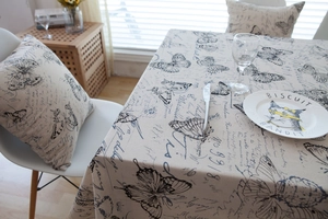 Close-up of vintage American style beige linen tablecloth with butterfly and script print