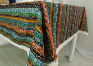 Detail of bohemian cotton linen tablecloth with geometric patterns and white lace edges