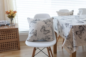 Macro detail of linen tablecloth with vintage butterfly print and elegant lace trim